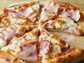 baked and sliced Ã¢â¬â¹Ã¢â¬â¹pizza with cheese, ham and sauce